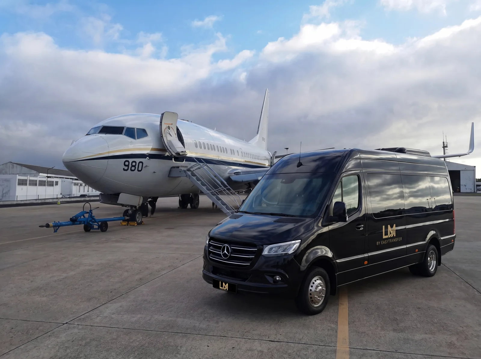 Chauffeur with luxury vehicle at airport